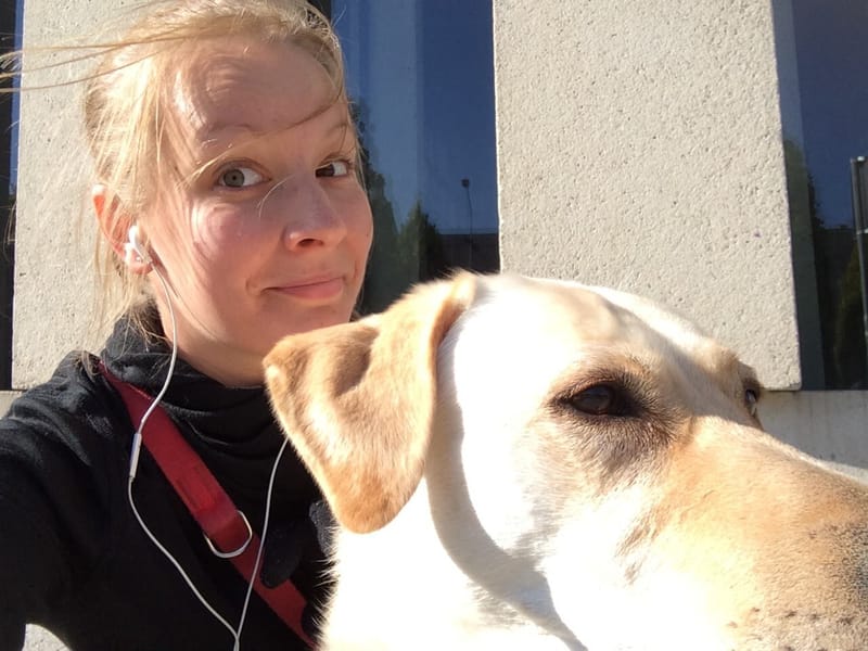 JJ taking a sunny selfie with a yellow Labrador